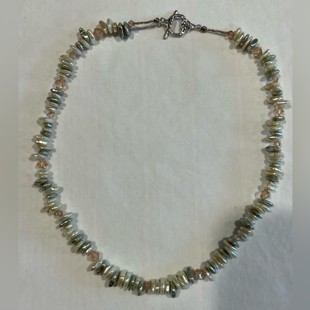 Pale green pearl necklace with silver toggle clasp.